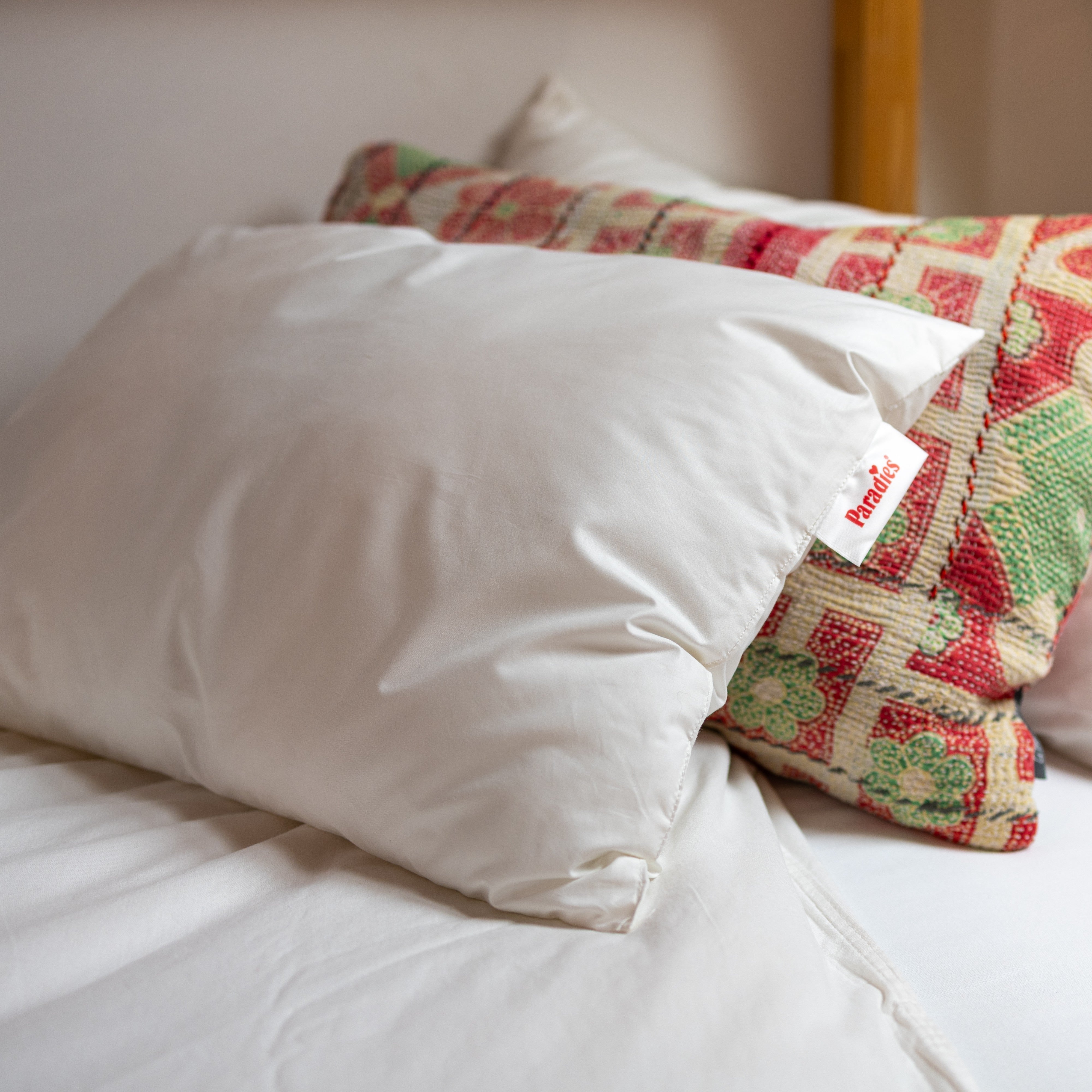Nahaufnahme Paradies Lani Kinderkissen mit farbigem Kissen auf Kinderbett